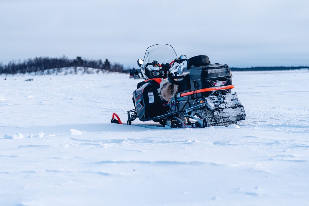 Selective focus shot of a snowmobile in the north of Sweden